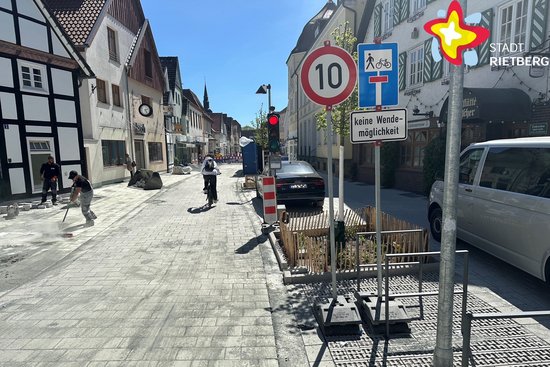 Blick in die umgestaltete Rathausstraße. Rechts steht eine mobile Ampel, die Rot zeigt.