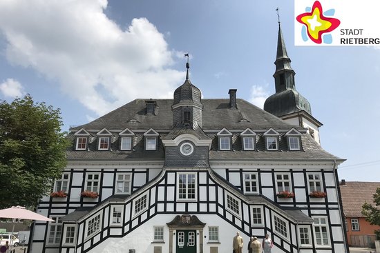 Das Historische Rathaus von Rietberg bei Sonnenschein. Die Aufnahme ist von der Rathausstraße aus gemacht worden. Der Himmel im Hintergrund ist blau mit einzelnen Wolken.